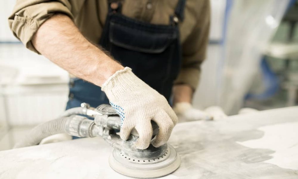 technician-polishing-auto-part-2023-11-27-05-01-53-utc-2